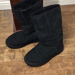 UGG black tall leather boots with shearling interior.